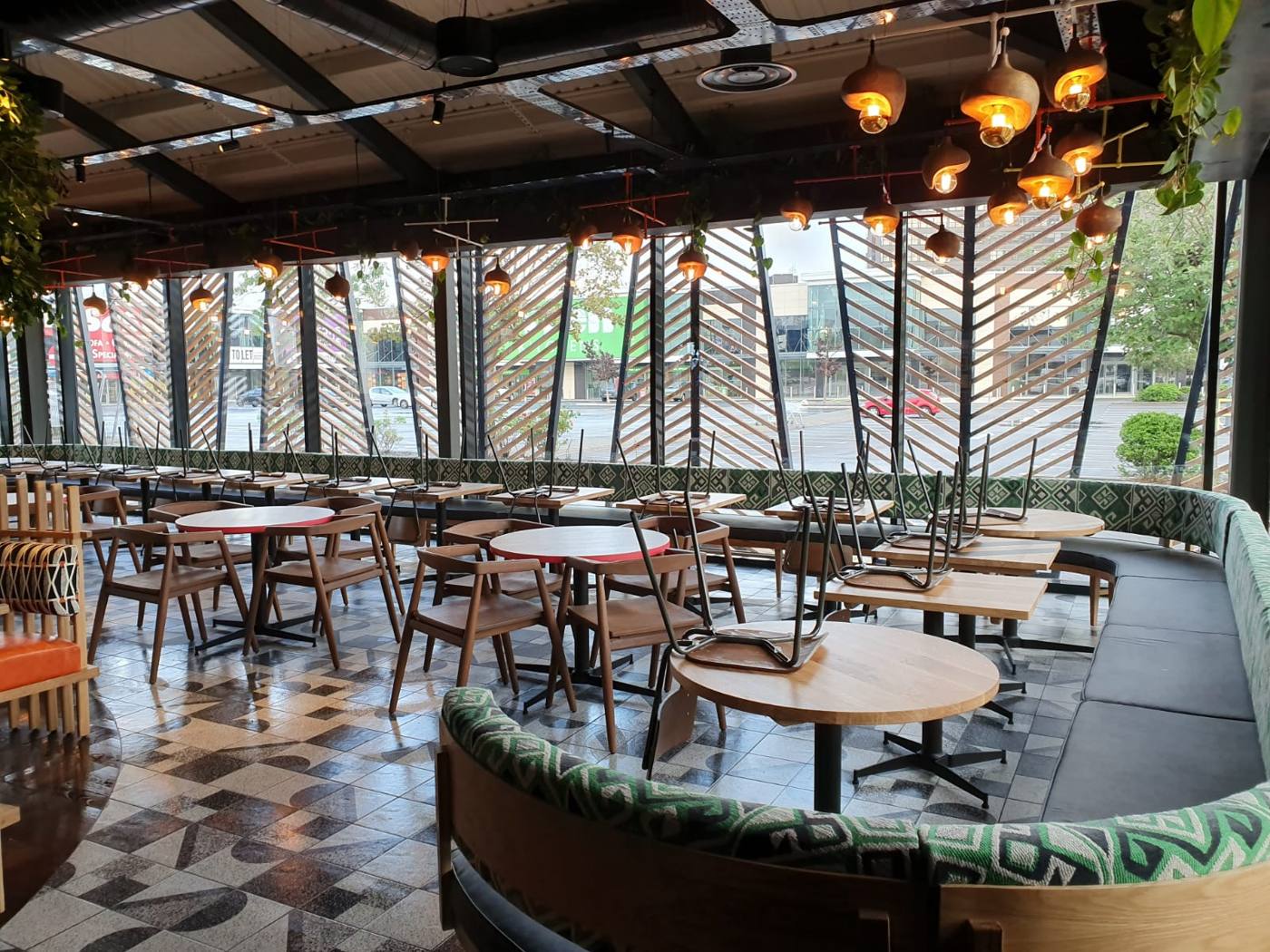 Restaurant dining area with rattan chairs cleaned after fit out